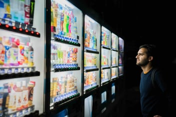 person looking at vending machine